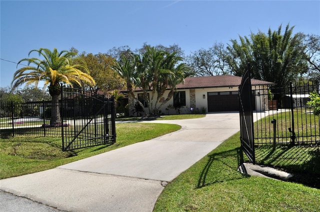 view of front of home with a gate, fence, a front lawn, and concrete driveway