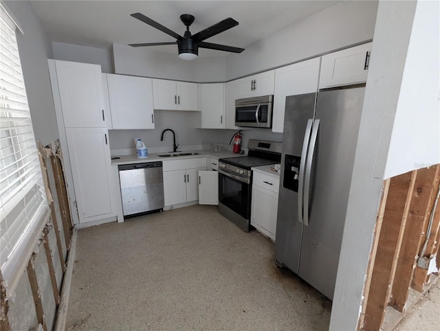 kitchen featuring ceiling fan, a sink, white cabinetry, light countertops, and appliances with stainless steel finishes