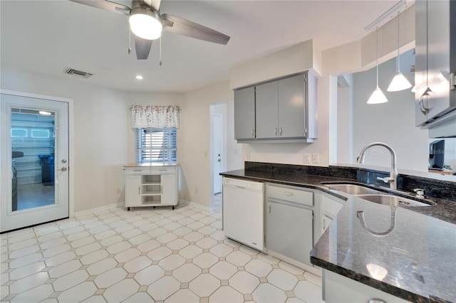 kitchen with light floors, gray cabinets, visible vents, white dishwasher, and a sink