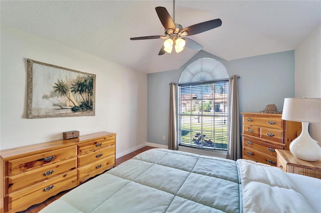 bedroom featuring vaulted ceiling, ceiling fan, and baseboards