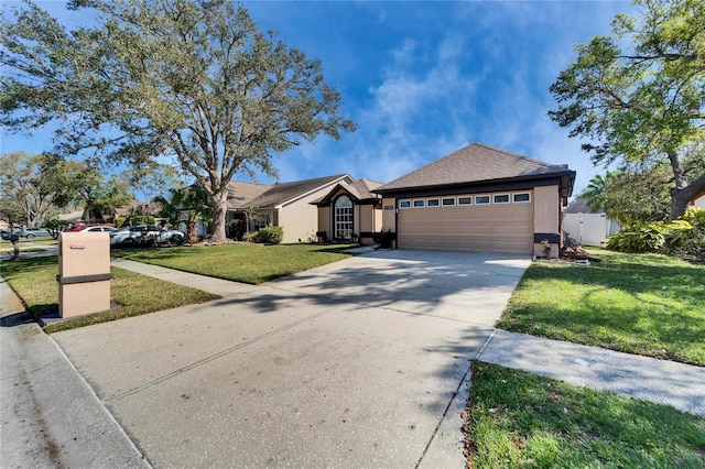 ranch-style house featuring driveway, a garage, a front lawn, and stucco siding