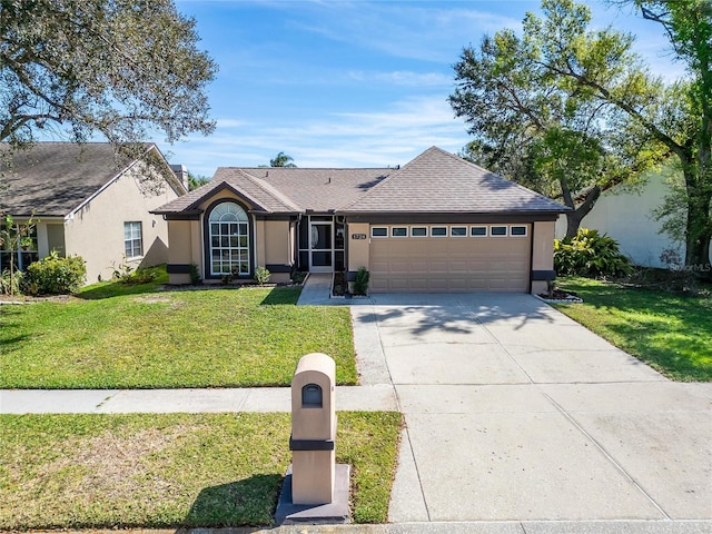 ranch-style home featuring a shingled roof, concrete driveway, an attached garage, a front lawn, and stucco siding