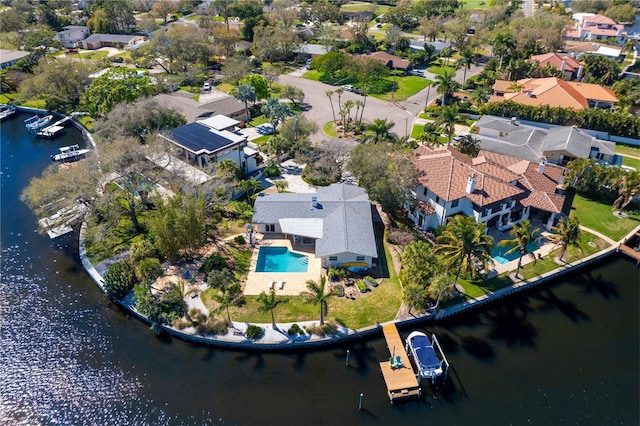 drone / aerial view with a water view and a residential view