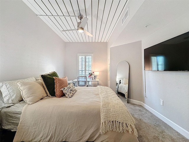 carpeted bedroom featuring a ceiling fan, visible vents, vaulted ceiling, and baseboards