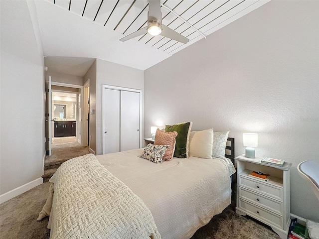 bedroom featuring a ceiling fan, baseboards, dark carpet, and a closet