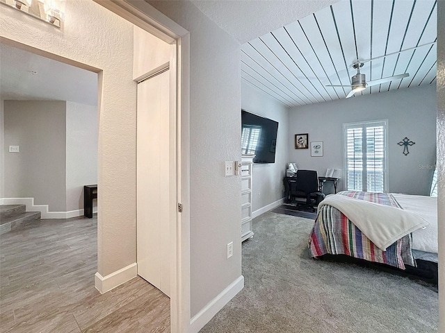 bedroom with baseboards and wood finished floors