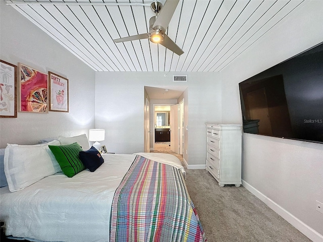 bedroom featuring baseboards, a ceiling fan, visible vents, and light colored carpet