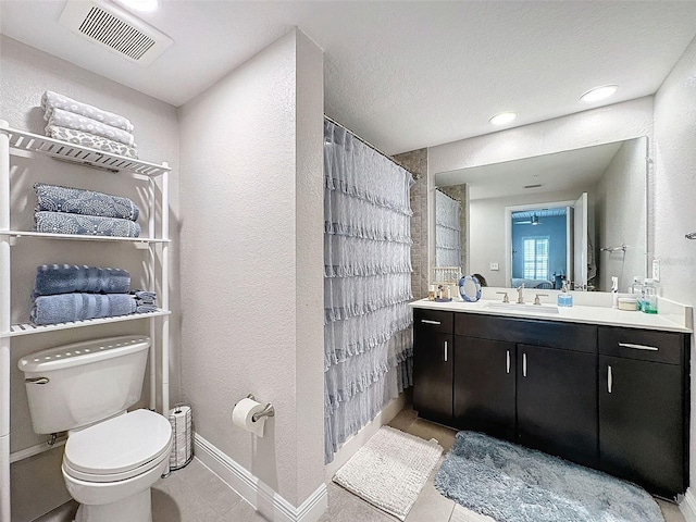 bathroom featuring baseboards, visible vents, toilet, a shower with curtain, and vanity