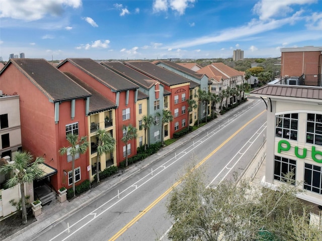 view of street with a residential view, curbs, and sidewalks