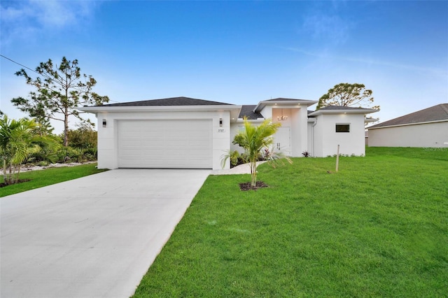 prairie-style house featuring a front yard, driveway, an attached garage, and stucco siding