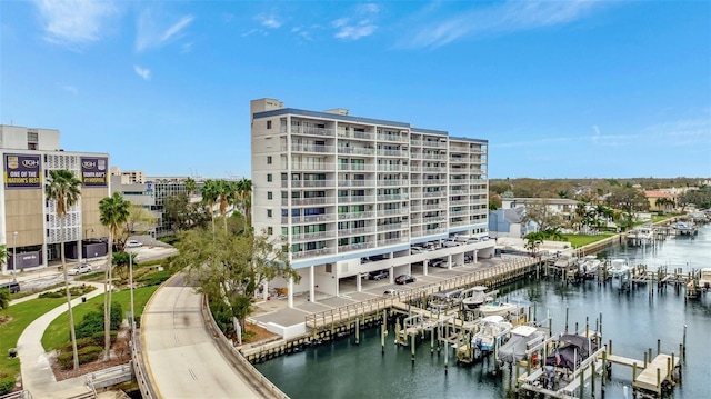 view of building exterior featuring a water view and boat lift