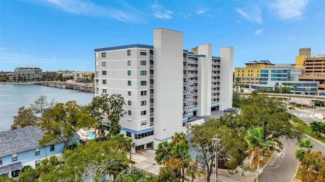 view of building exterior featuring a water view and a city view