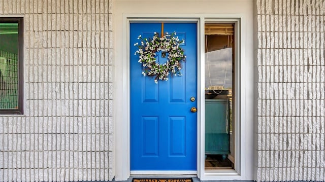 doorway to property featuring stucco siding