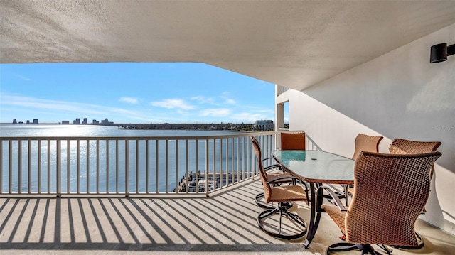 balcony with a view of city and a water view