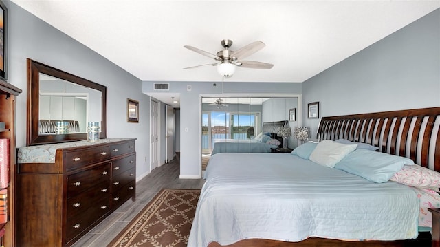 bedroom featuring a ceiling fan, baseboards, visible vents, and dark wood-style flooring