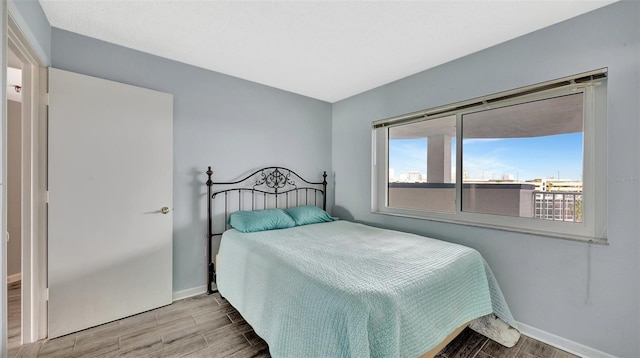 bedroom with wood tiled floor and baseboards