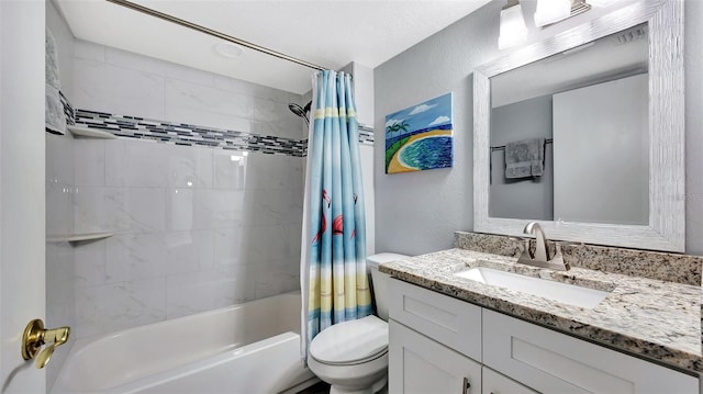 full bath with toilet, shower / bathtub combination with curtain, vanity, and a textured wall