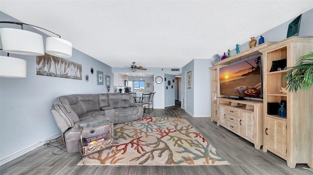 living area with visible vents, ceiling fan, a textured ceiling, wood finished floors, and baseboards