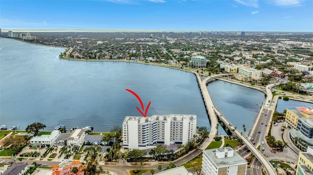 birds eye view of property with a water view and a city view