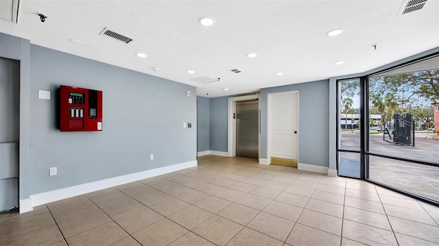 unfurnished room with visible vents, baseboards, and light tile patterned floors