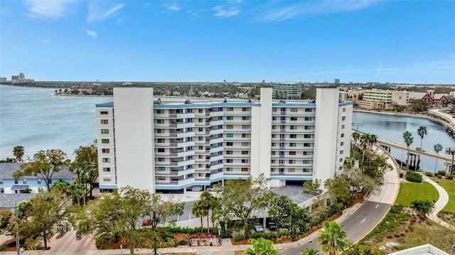 view of building exterior featuring a water view and a city view