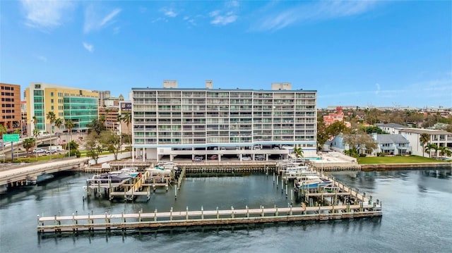 view of building exterior featuring a water view and a view of city