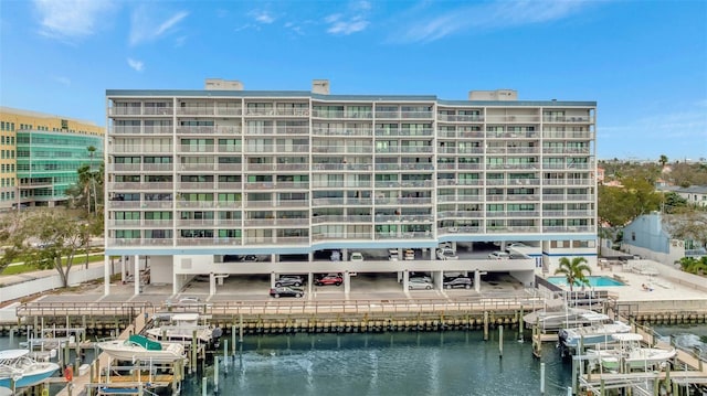 view of building exterior featuring a water view and boat lift