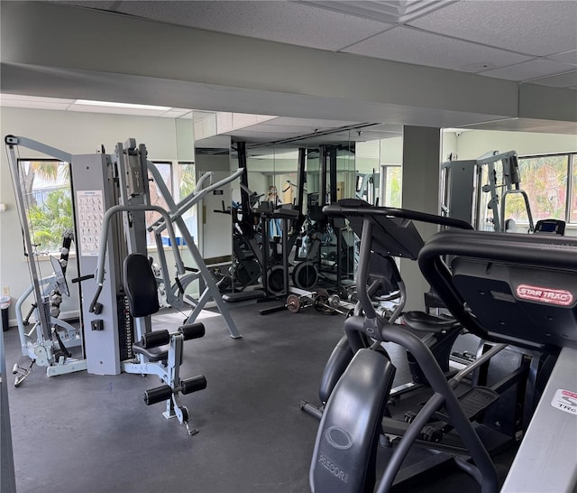 workout area with a wealth of natural light and a drop ceiling