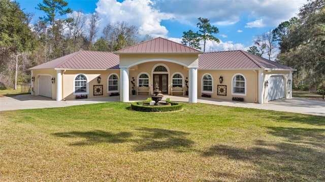 mediterranean / spanish-style house with french doors, stucco siding, a garage, driveway, and a front lawn