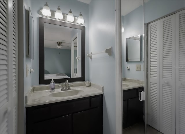 full bathroom with a closet, vanity, and ensuite bath