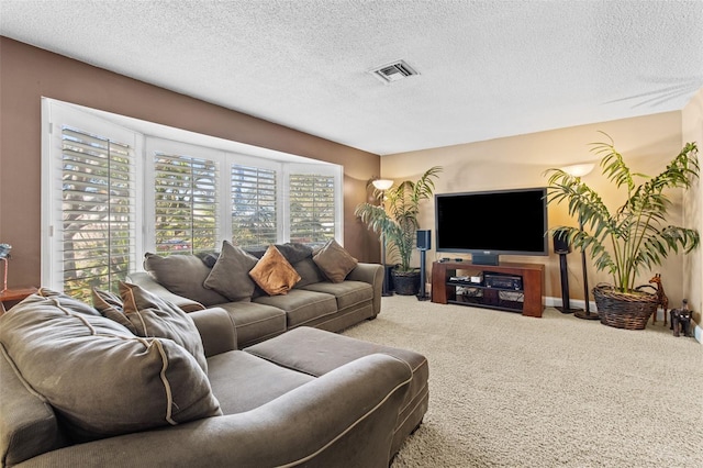 living room with a textured ceiling, visible vents, and carpet flooring