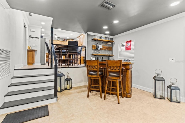 bar featuring recessed lighting, visible vents, stairs, a dry bar, and crown molding