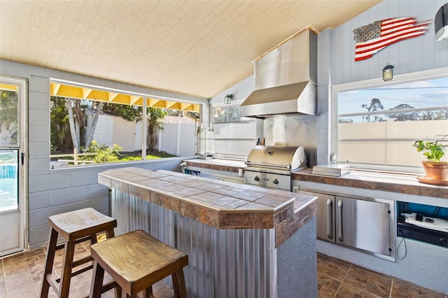 view of patio with area for grilling and outdoor wet bar