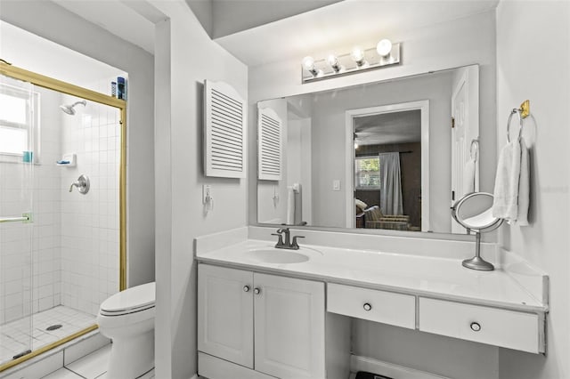 ensuite bathroom featuring a stall shower, vanity, toilet, and ensuite bathroom