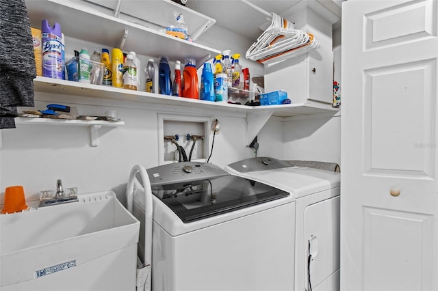 laundry area featuring cabinet space, a sink, and independent washer and dryer