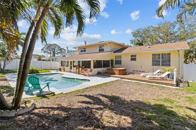 rear view of house featuring a fenced in pool, a fenced backyard, a jacuzzi, and a patio