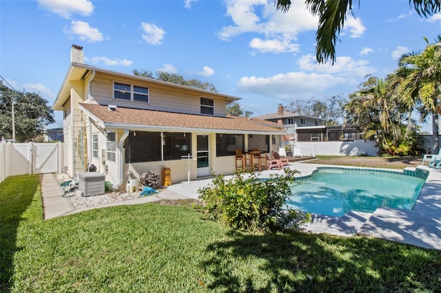 back of property with a fenced backyard, outdoor dry bar, a gate, a chimney, and a patio area