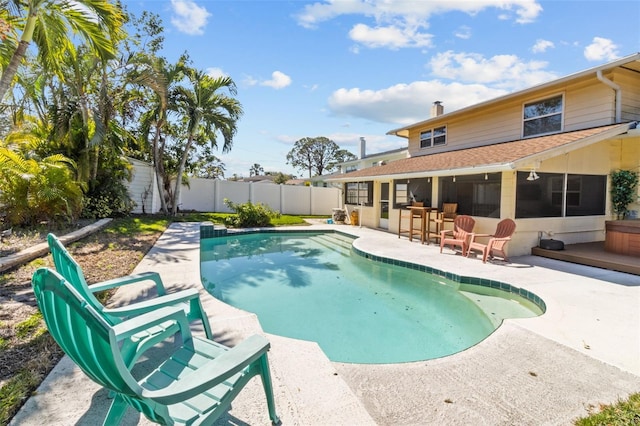 view of pool featuring a fenced in pool, a patio area, an outdoor bar, and a fenced backyard