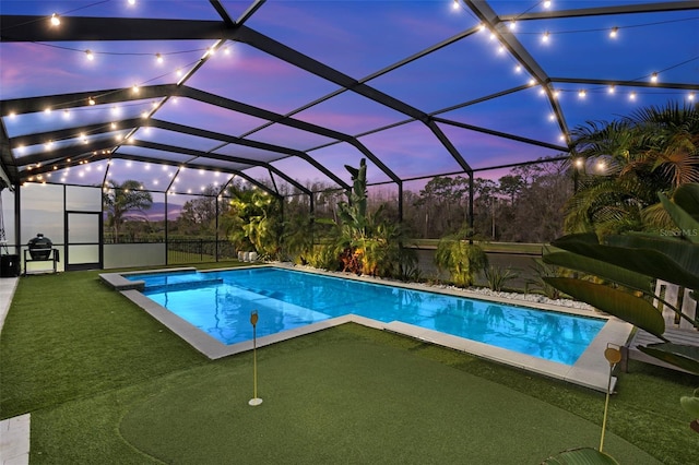 pool with glass enclosure and a patio