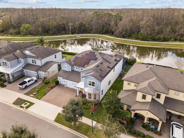 aerial view featuring a water view, a forest view, and a residential view