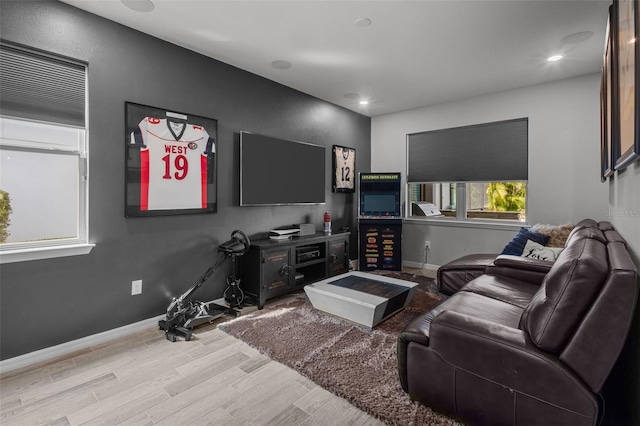 living area featuring recessed lighting, baseboards, and light wood finished floors