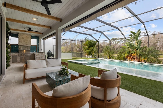 pool with exterior kitchen, a patio area, a lanai, and an outdoor living space