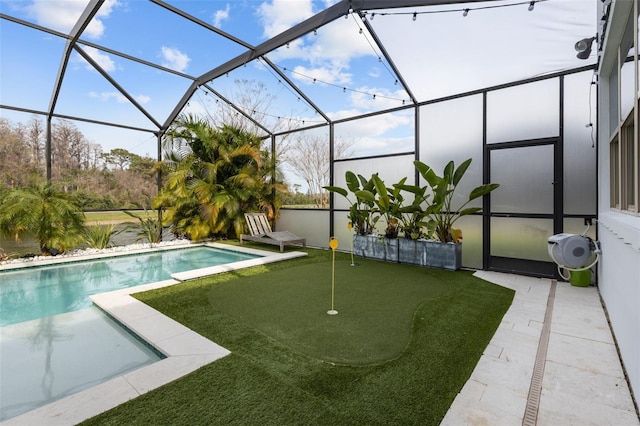 outdoor pool with a lanai and a patio area