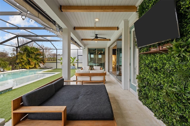 sunroom / solarium with beamed ceiling and a ceiling fan