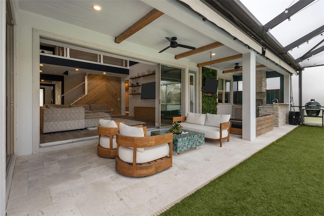 view of patio / terrace featuring a ceiling fan, a lanai, outdoor lounge area, and an outdoor kitchen