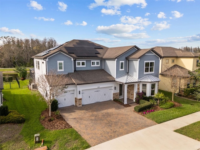 view of front of house featuring fence, decorative driveway, and a front yard