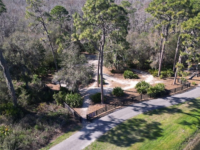 view of property's community with fence and a lawn