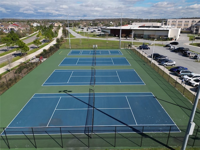 view of sport court featuring a residential view and fence