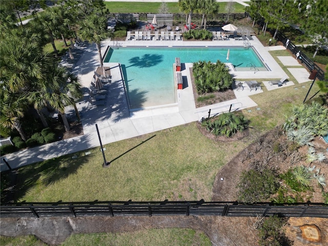 community pool featuring a yard, a patio area, and fence