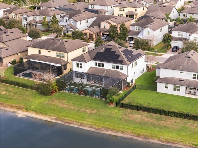 drone / aerial view with a residential view and a water view